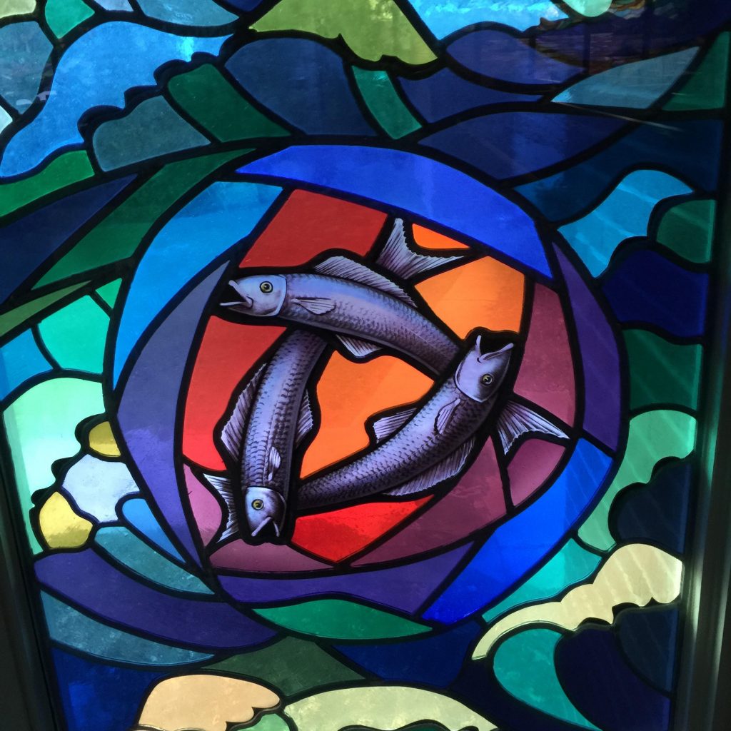 stained window image of 3 fishes
